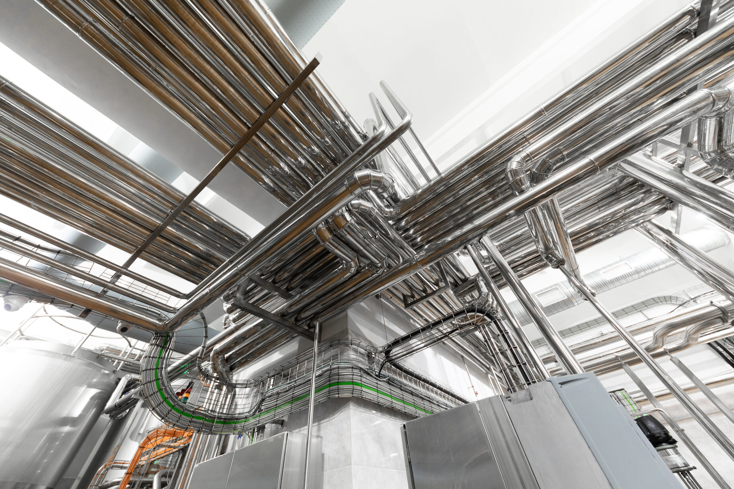 Modern industry equipment, cables and piping inside in manufacture background